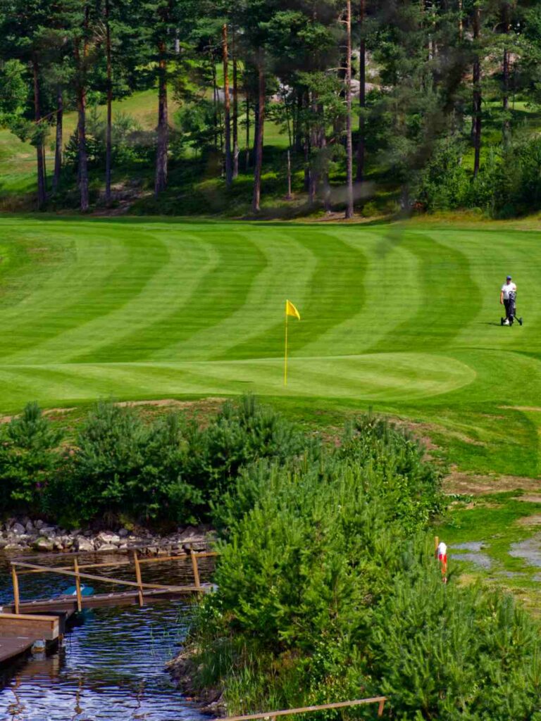 Stunning view of Vrådal Golf Course situated next to the serene lake.