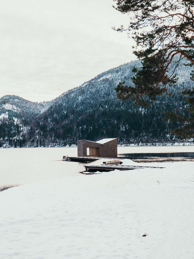 Exterior view of Soria Moria Sauna in the midst of a winter wonderland.